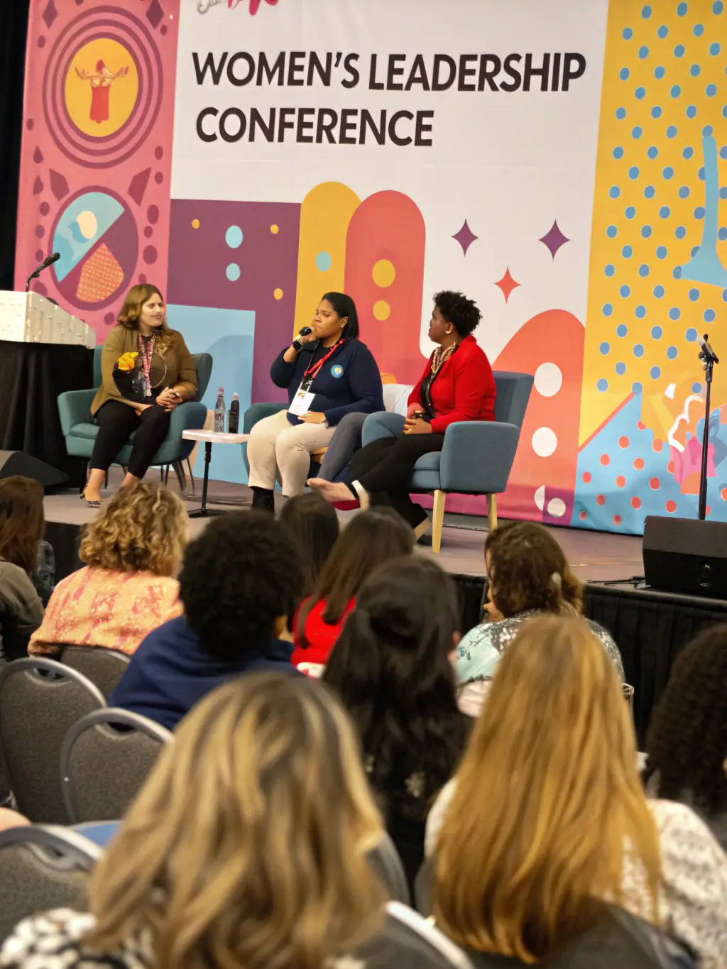 A close-up shot of a panel discussion featuring fashion designers and industry experts, highlighting their interaction and the exchange of ideas.